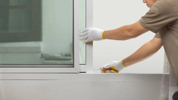 Technician servicing patio door system